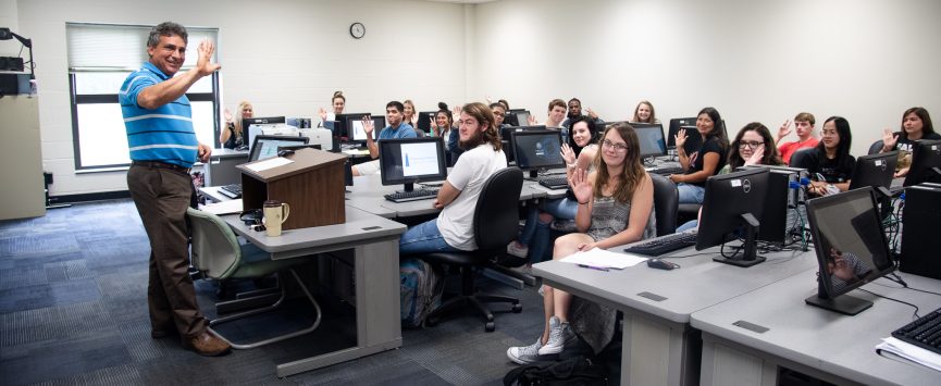 Coastal Students in computer lab waving